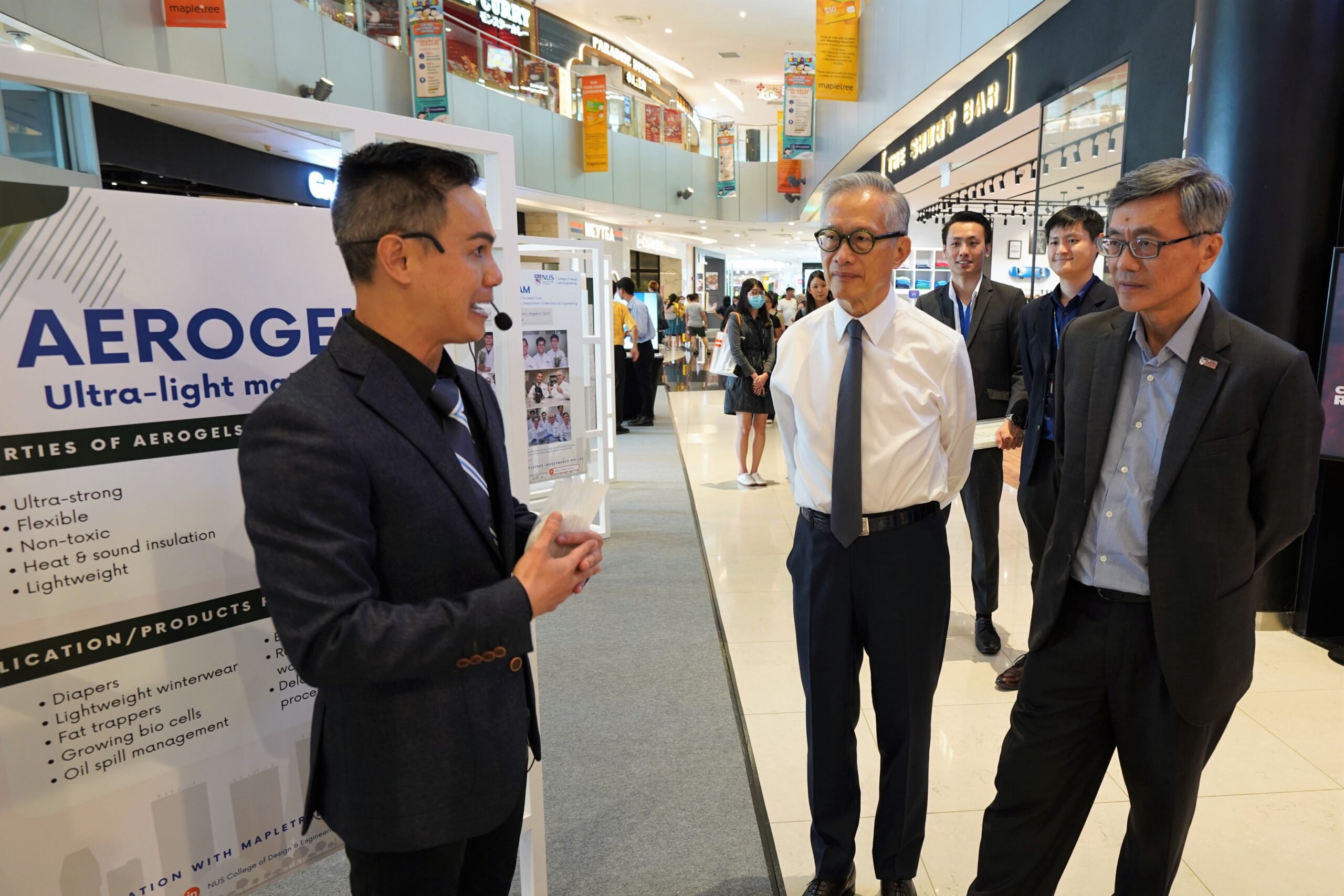 Assoc Prof Duong Hai Minh (left), lead researcher behind the aerogels, introduces the exhibits to Mr Edmund Cheng (centre) Chairman of Mapletree, and Prof Tan Eng Chye (right), NUS President.