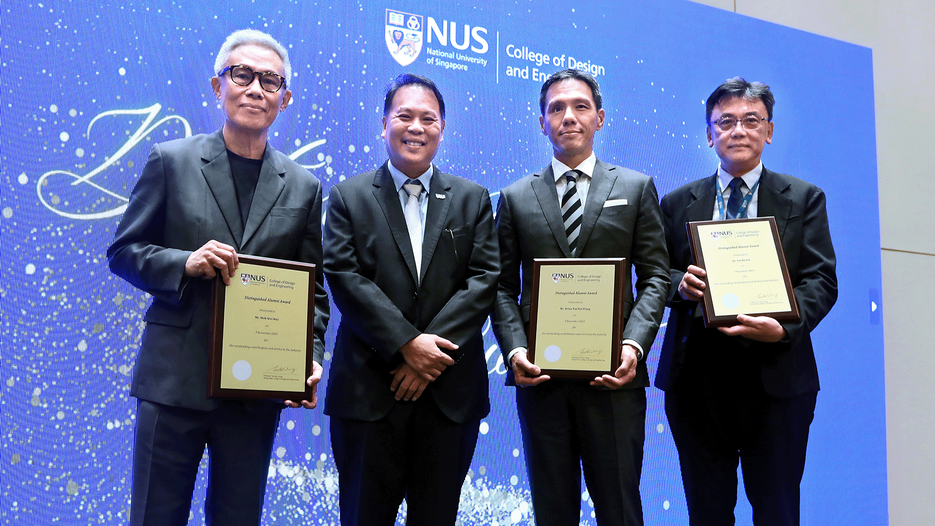 Recipients of the Distinguished Alumni Award 2023: (left) Mr. Mok Wei Wei; (centre right) Mr. Brian Tan Kai Piang; (right) Dr. Teo Ho Pin - represented by  Prof Michael Chew, Head Dept of Built Environment. Pictured with (centre left) CDE Acting Dean, Prof Teo Kie Leong.