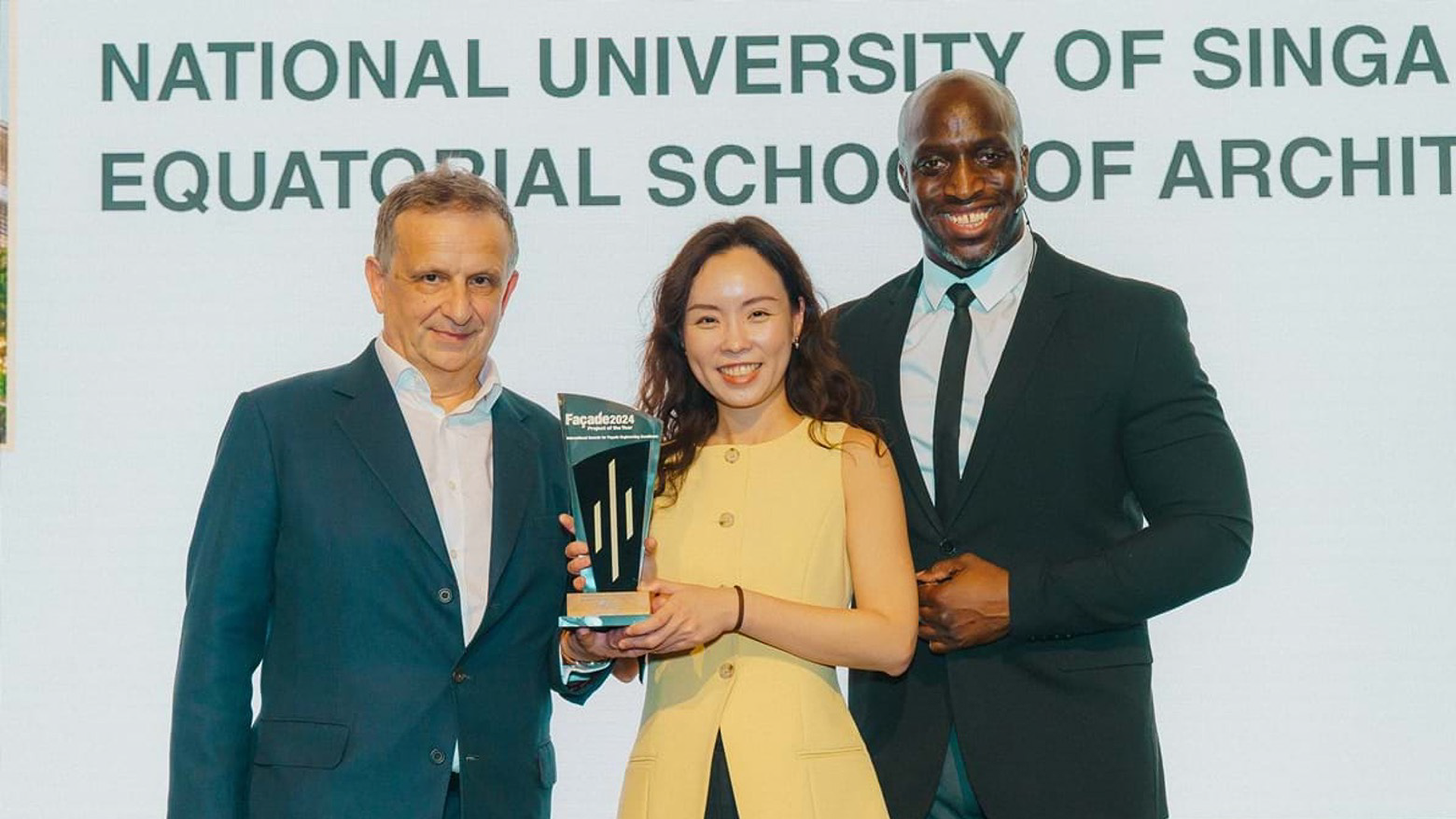 NUS Architecture Alum Victoria Thong (centre) received the award on behalf of the project team. Pictured with (right) Emmanuel Sonubi, event host, and (left) Steve Bosi, Head of Facade Engineering from WSP. (Photo courtesy of SFE)