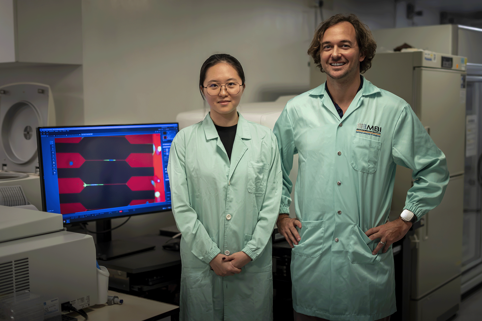 Asst Prof Andrew Holle (right), who led the study, with Li Yixuan, a fourth-year PhD student in the Mechanobiology Institute and first author of the research paper.
