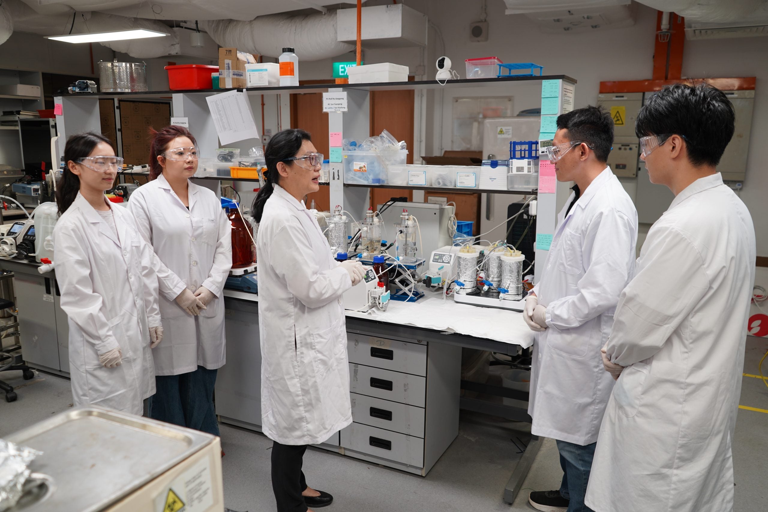Prof Hu Jiangyong advising her researchers at the Centre for Water Research