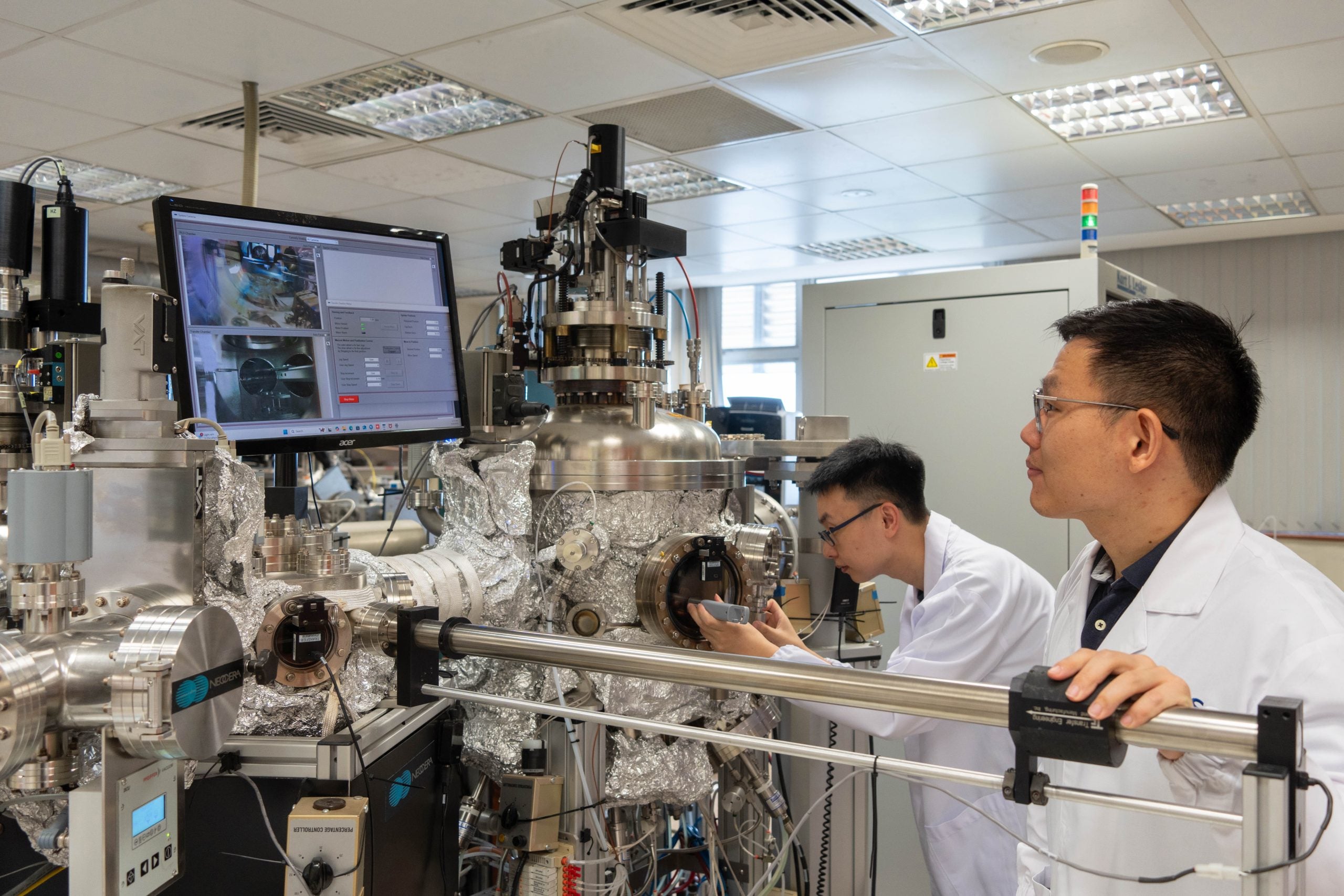 DSC03850-02 Dr Zhenyi Zheng, a member of the research team, loading a sample into the magnetron sputtering equipment