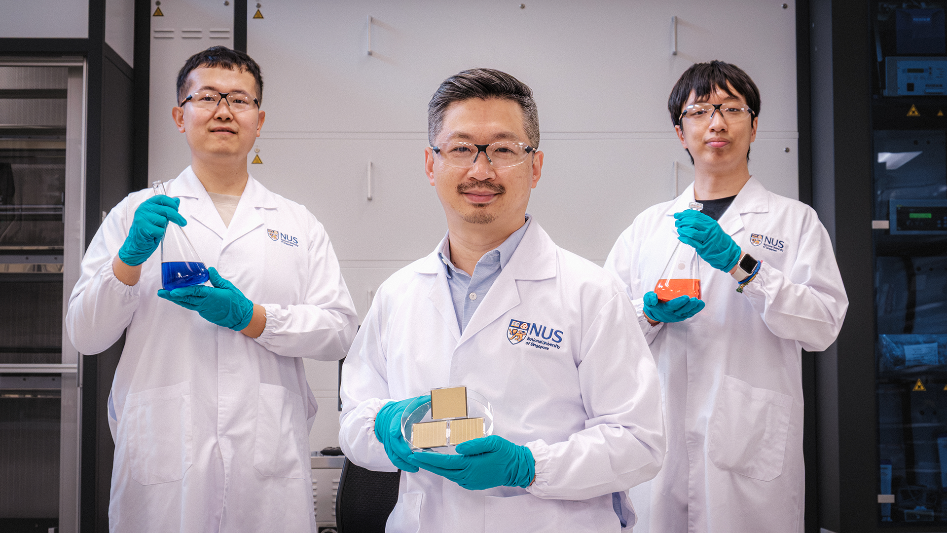 Assistant Professor Hou Yi (middle), Dr Jia Zhenrong (left), Mr Guo Xiao (right) and their team achieved a record power conversion efficiency of 26.4% with a new perovskite-organic tandem cell design (held by Asst Prof Hou).