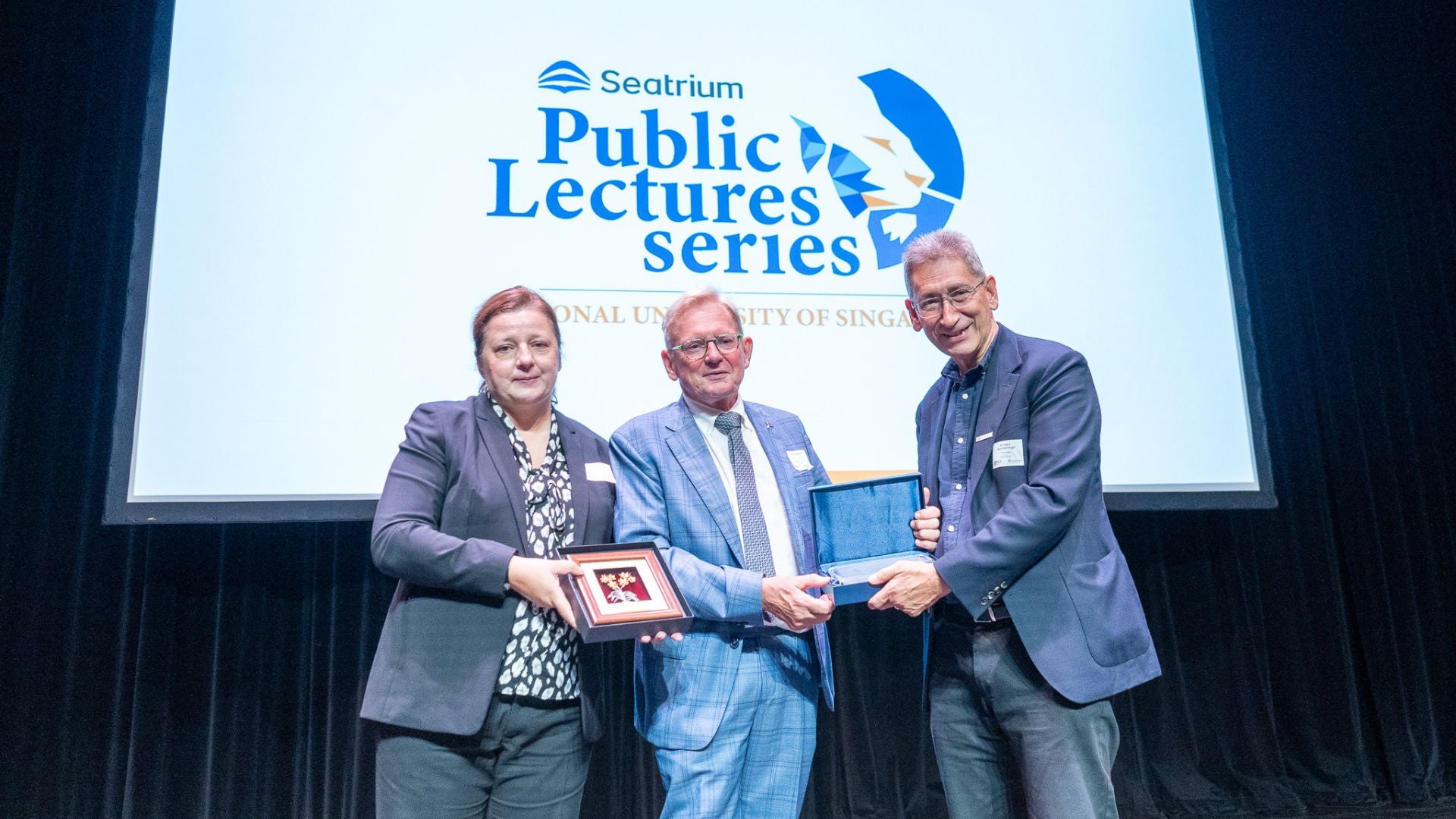Prof Silvija Gradečak-Garaj, together with Mr Mark Gainsbourough, presents a token of appreciation to Prof Gerard van Bussel at the Seatrium Public Lecture.