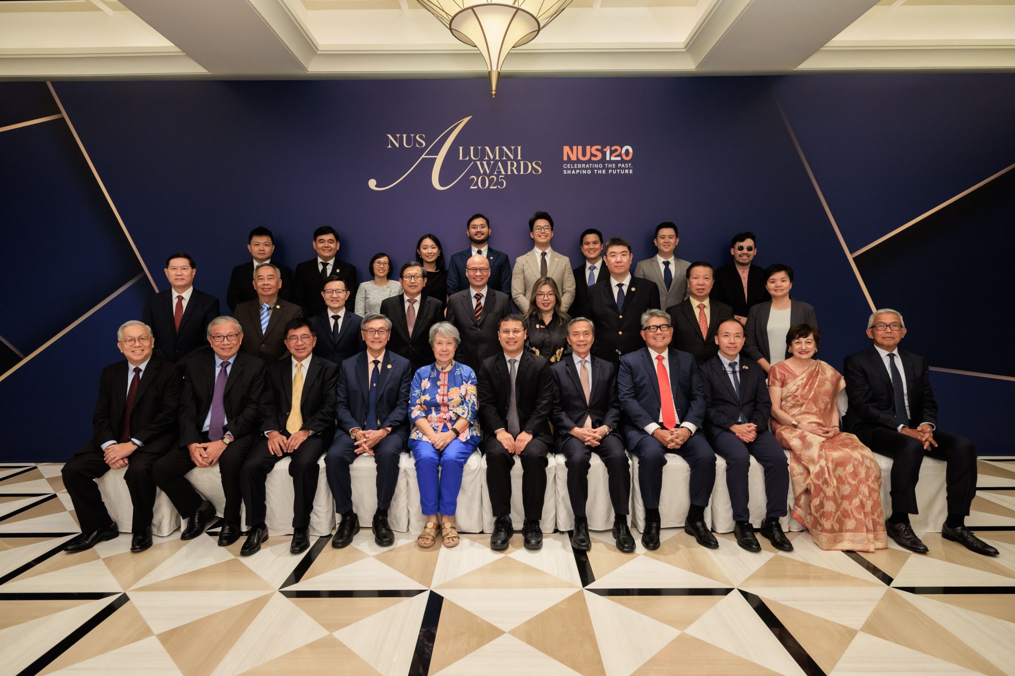 NUS honoured the achievements of 22 outstanding alumni at the prestigious NUS Alumni Awards 2025. Amongst attendees were (front row) NUS President Prof Tan Eng Chye (fourth from left), Guest-of-Honour, Mr Desmond Lee, Minister for Education and Minister-in-Charge of Social Services Integration (centre), NUS Chairman Mr Hsieh Fu Hua (fifth from right), and NUS Deputy President (Academic Affairs) and Provost Prof Aaron Thean (third from right).