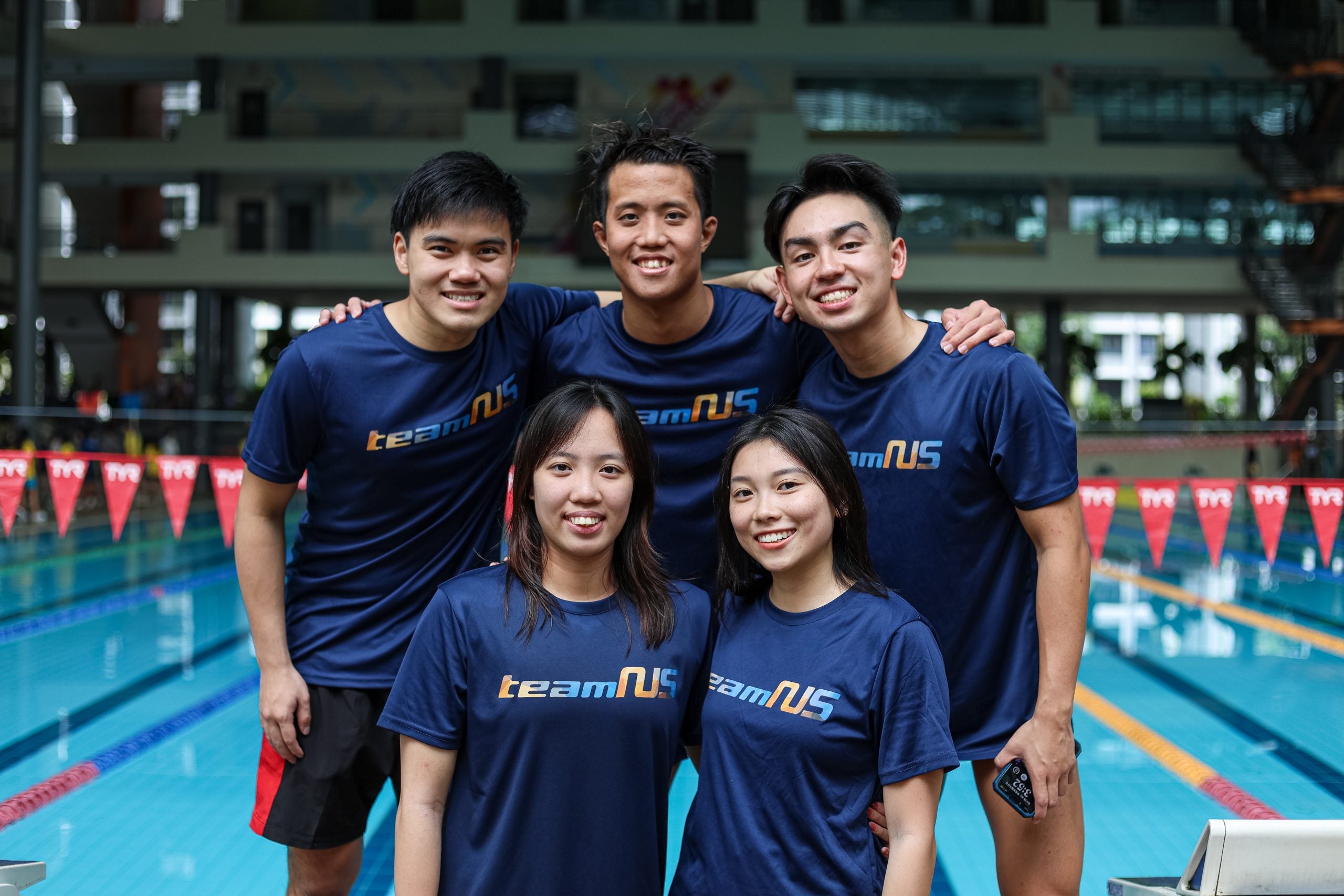 Brien Lim (top row, middle) with his peers from NUS varsity swim team