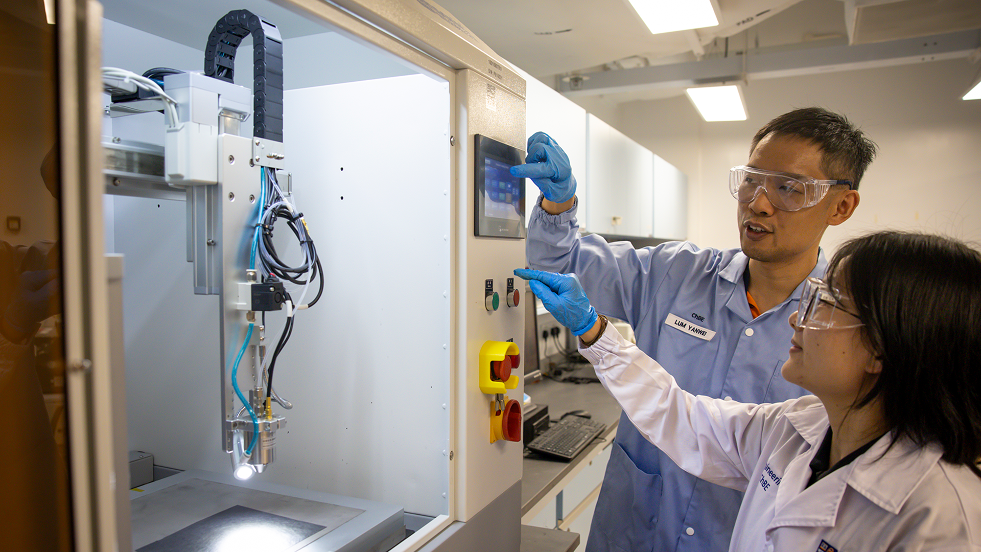 Asst Prom Lum Yanwei with a member of his research team at work in his lab.