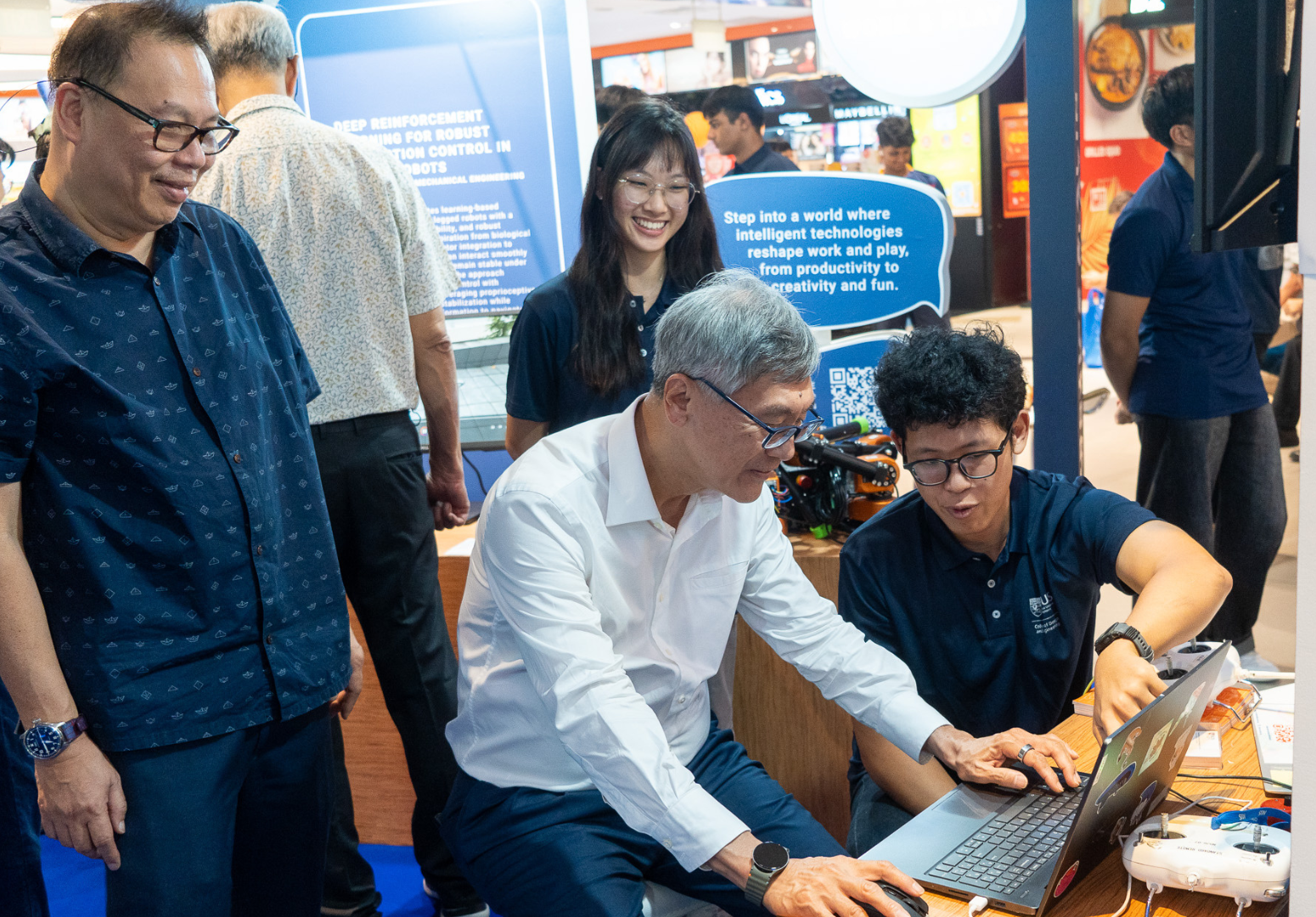 nus-cde-robotics-meet-ai-showcase-funan-nus-president-playing-calibur-robotics