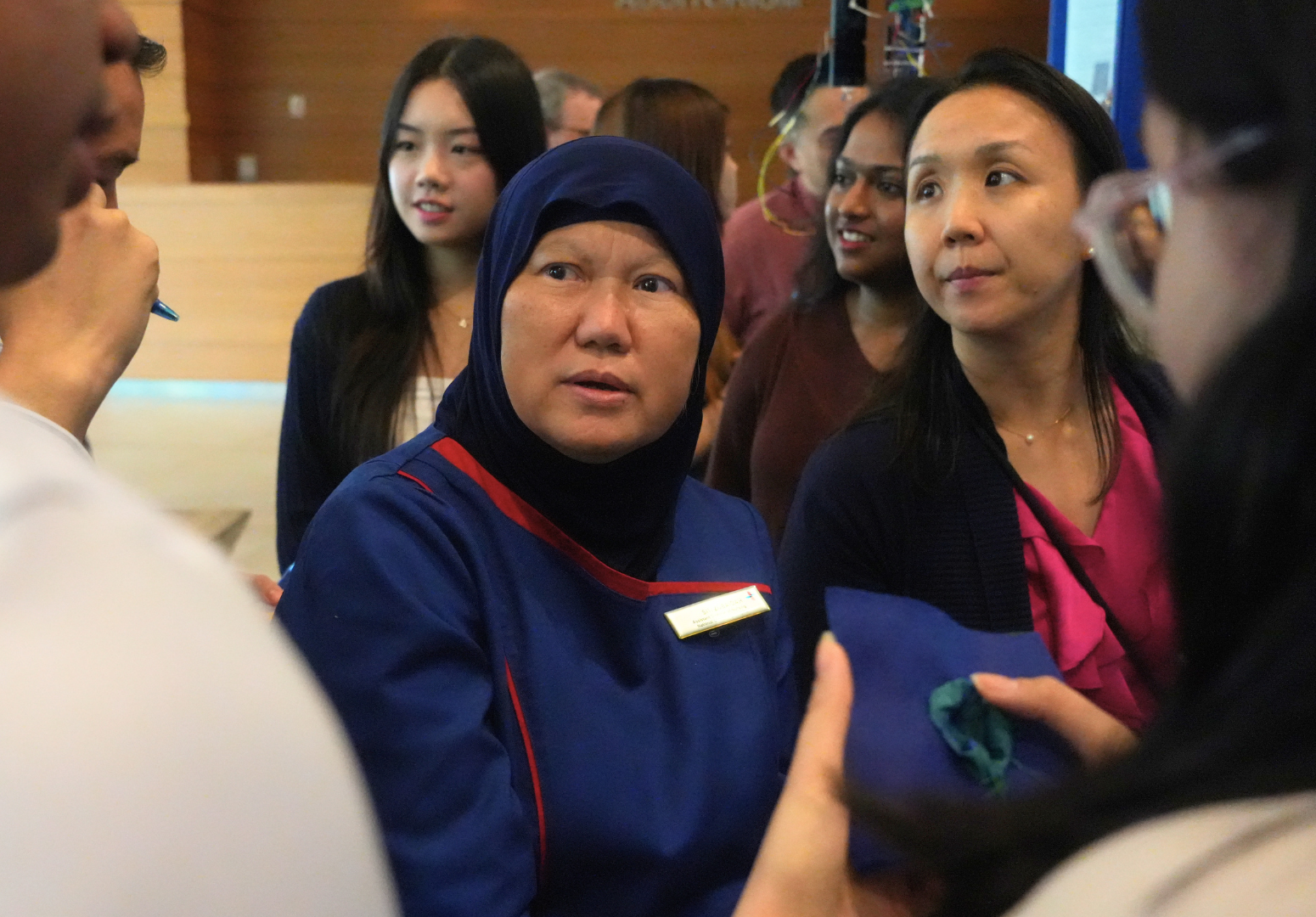 Ms Siti Zubaidah Bte Mordiffi, Assistant Director (Research), NUH Nursing Administration, hearing from students at the showcase.