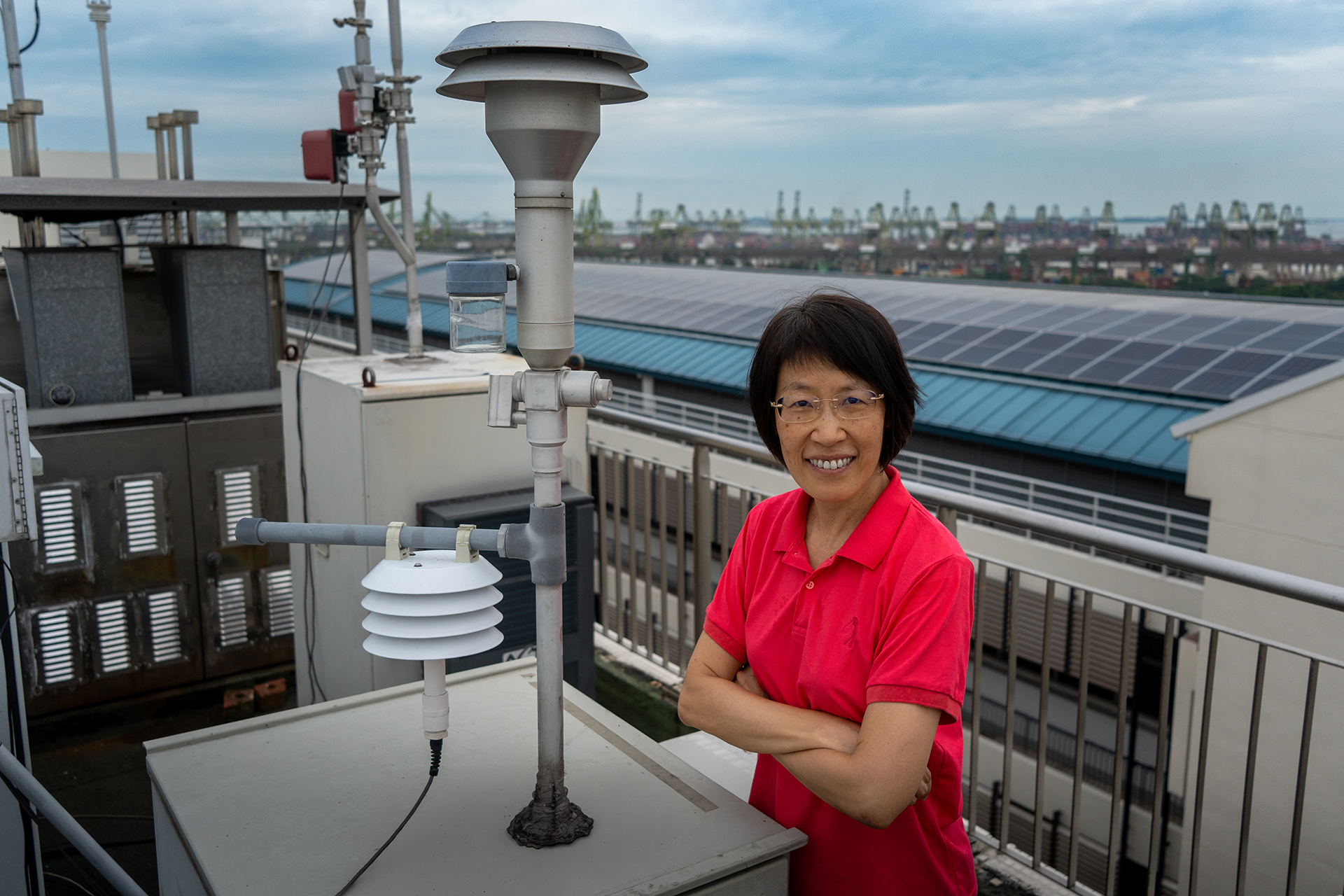 Assoc Prof Yu Liya at a rooftop air-quality monitoring station used in her research to study the chemical clues carried in Singapore’s air.