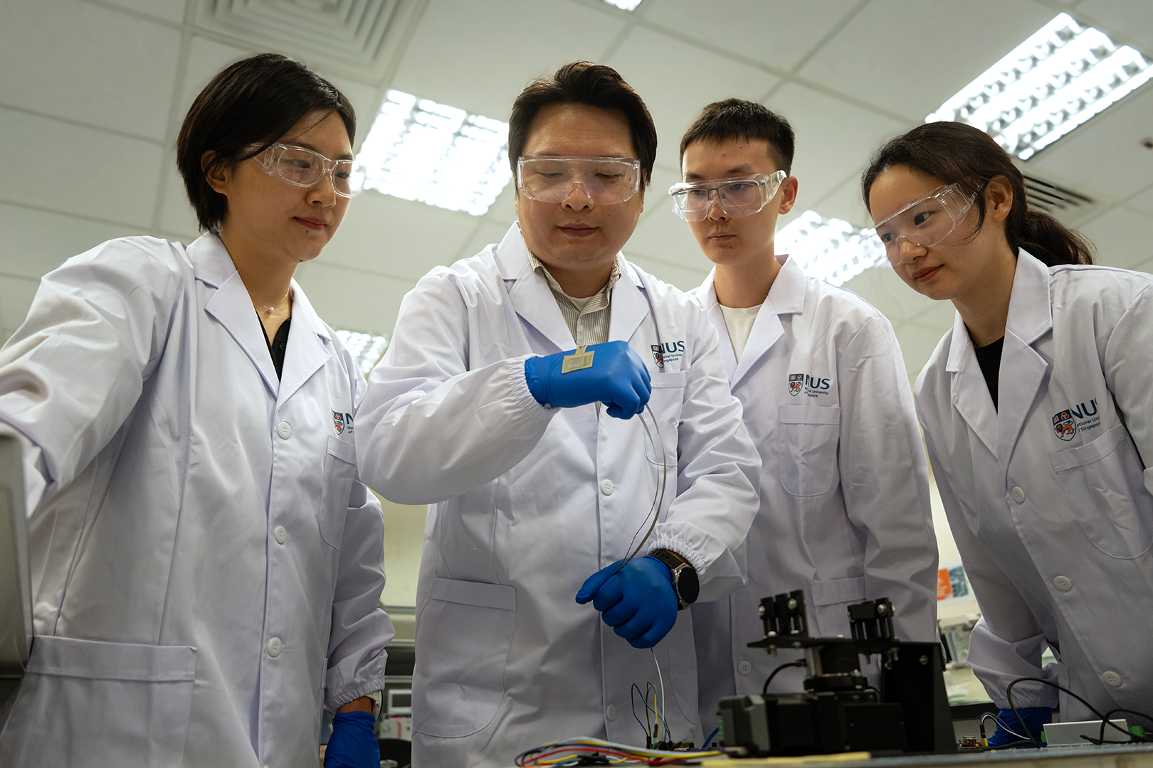 Asst Prof Zhai Wei, Research Fellow Dr Dang Chao, PhD candidates Qi Haobo and Jin Yidan (from left to right) test the performance of soft skin sensors based on the reported substrate.