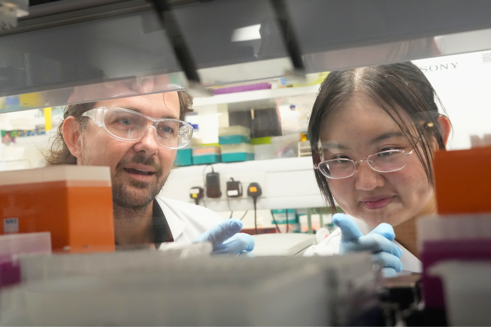 Asst Prof Andrew Holle (left) and PhD student Nicole Lee Jia Wen (right) in the laboratory.