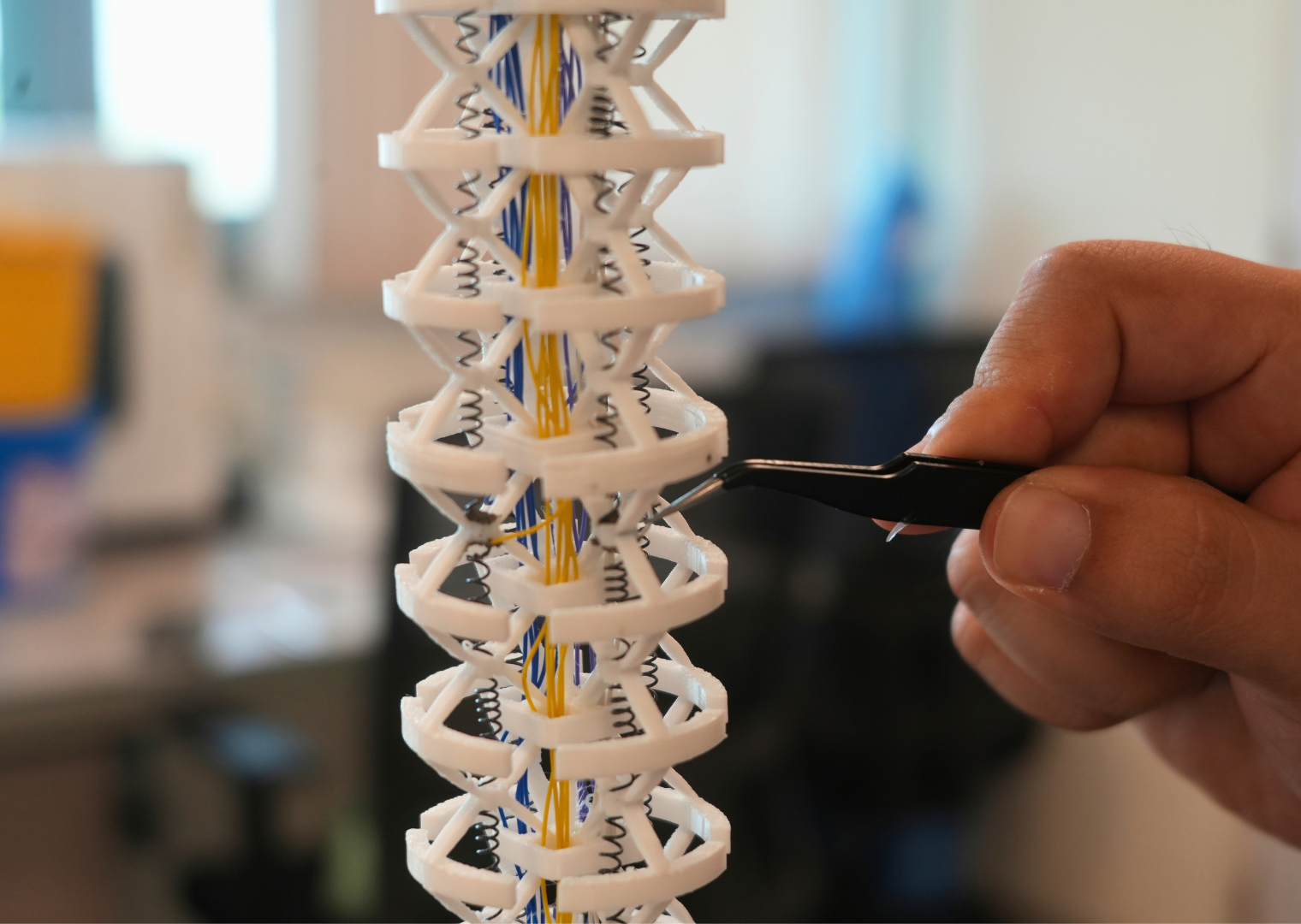 Wire Bonding Junctions (WBJs), inspired by the octopus’s neuromuscular junctions (NMJs), are distributed along the soft robotic arm