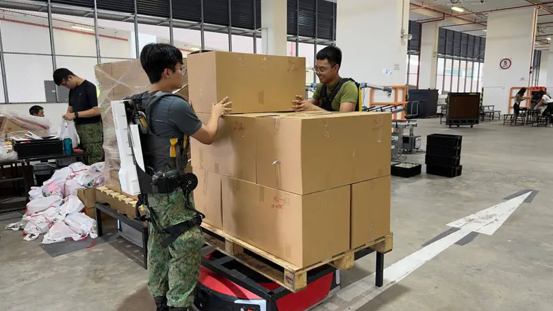 SAF personnel fitted with exoskeleton suits to assemble NDP packs