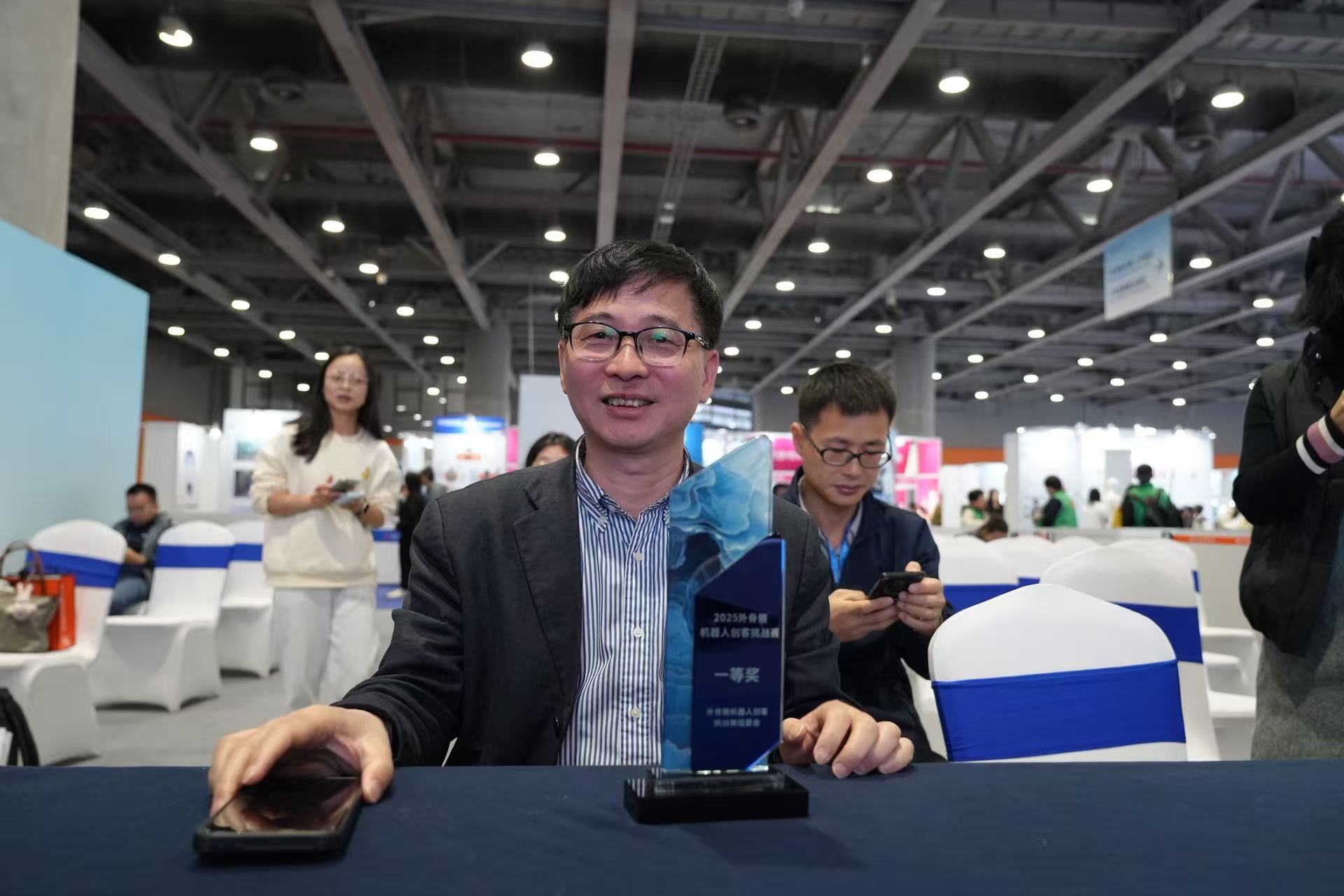 Dr. Yu proudly holding a medal