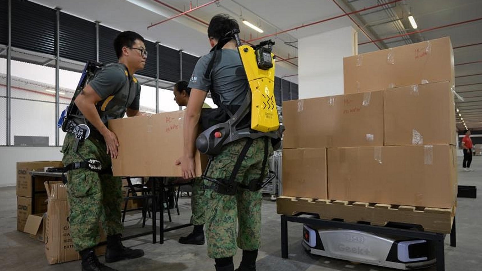 Soldiers-don-exoskeleton-suits Photo Credit: Ng Sor Luan, The Straits Times