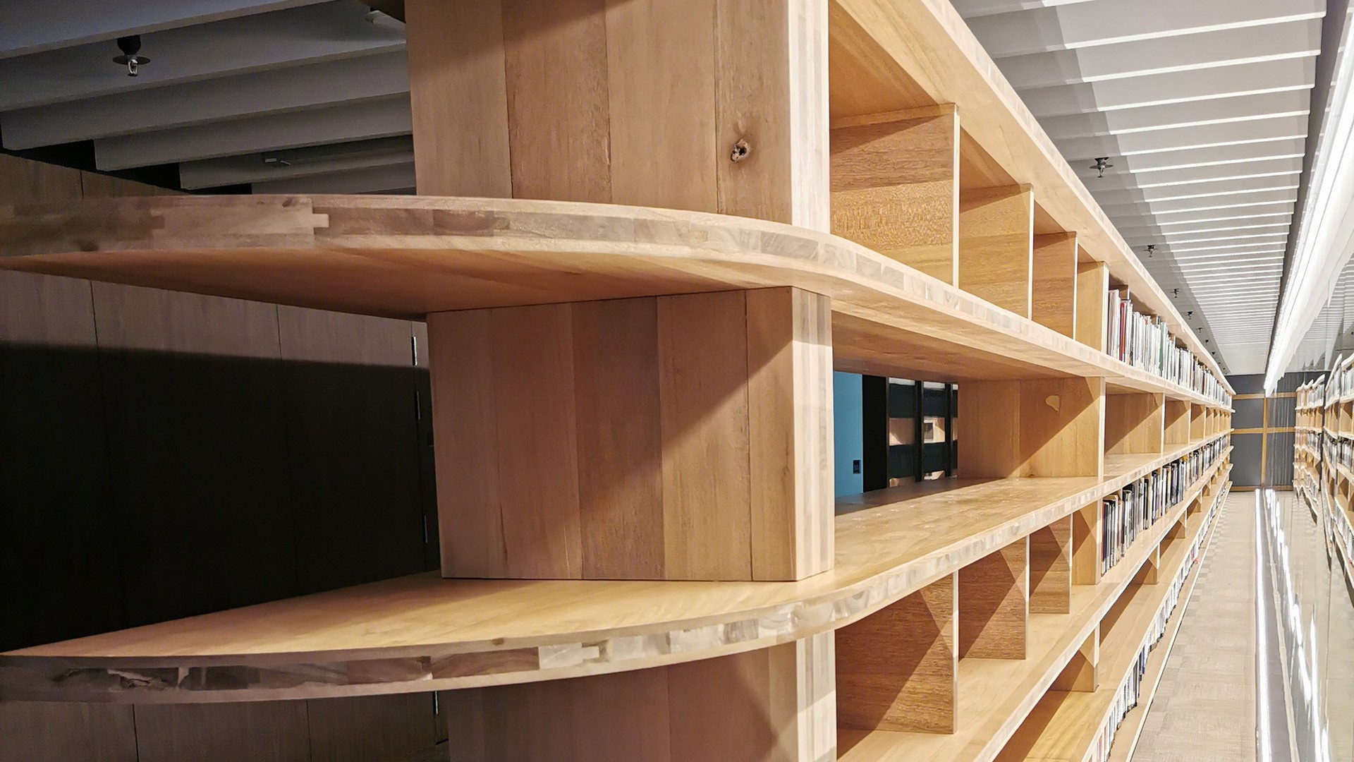 The BookBridge's three-layer composite shelves comprise acacia as inner layers and Forest Stewardship Council certified meranti wood as outer layers.