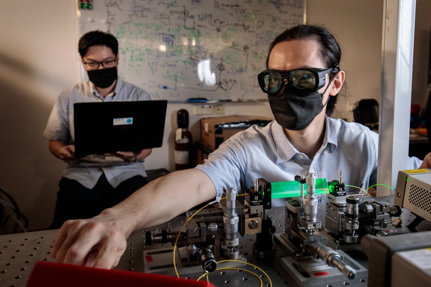 Assistant Professor Charles Lim (back) and Dr Zhang Gong (front) with their team’s first-of-its-kind quantum power limiter device.