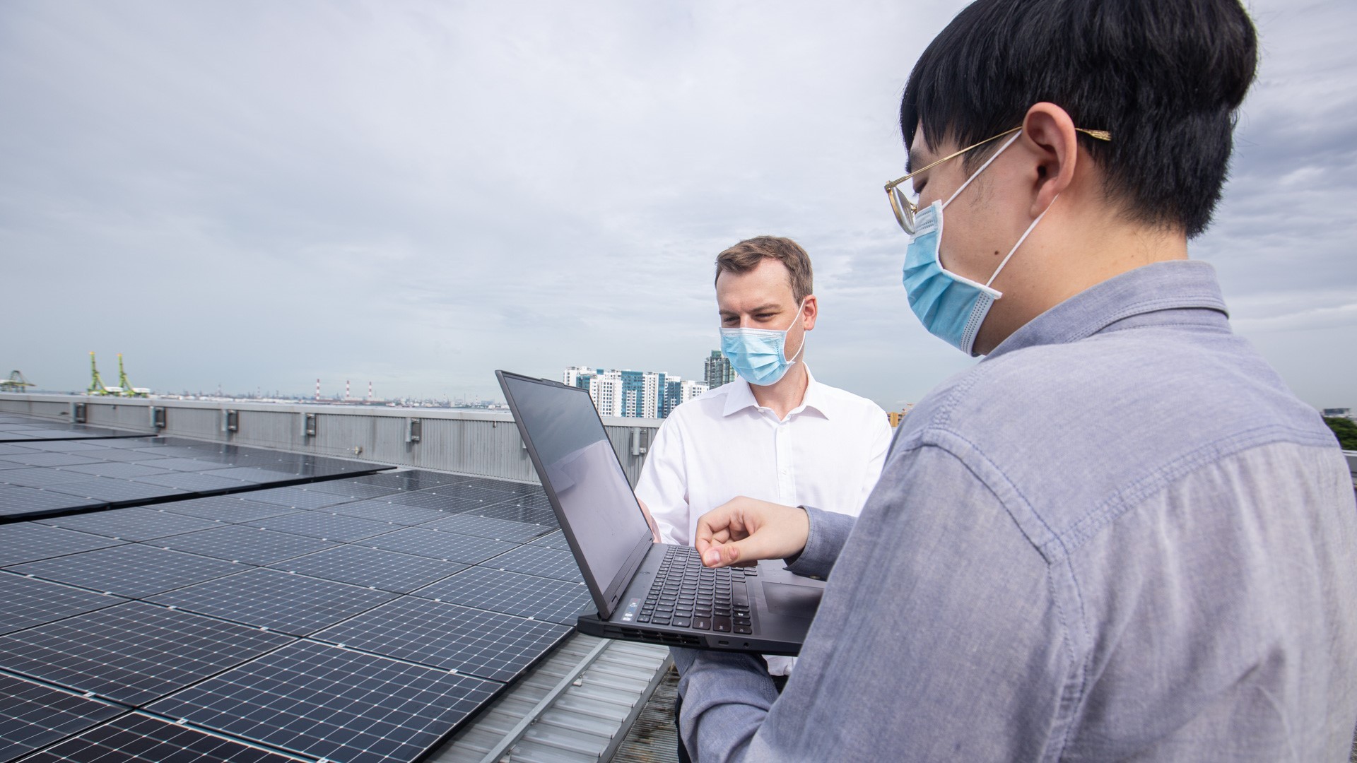 Dr Filip Biljecki (left) and Mr Abraham Noah Wu (right) at the solar roof of the SDE4 building.