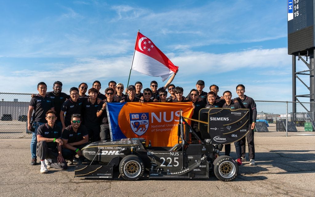 Students and staff team members of R24e electric race car