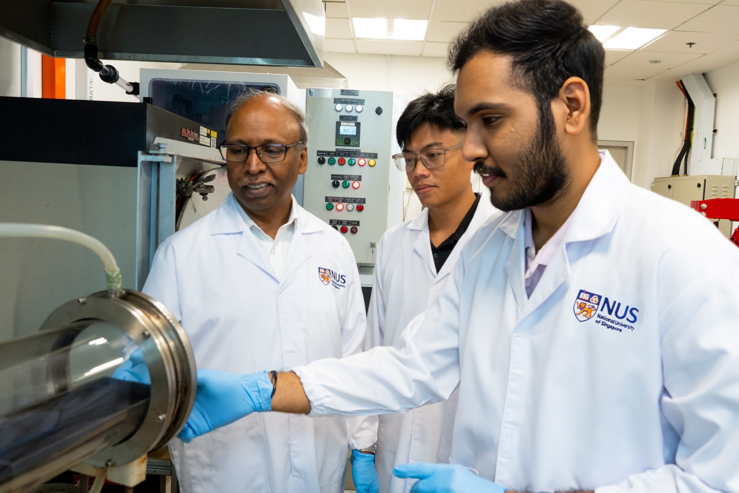 Assoc Prof Palani Balaya (left) and his team investigating synthesis of the zinc-doped Na3V2(PO4)3/C cathode material using a quartz tube furnace. 